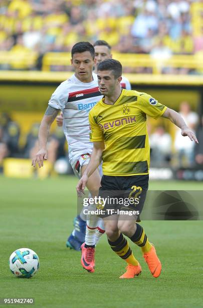 Charles Aranguiz of Leverkusen and Christian Pulisic of Dortmund battle for the ball during the Bundesliga match between Borussia Dortmund and Bayer...