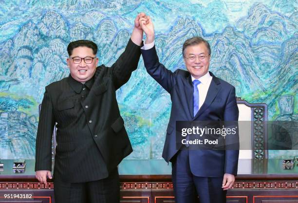 North Korean leader Kim Jong Un and South Korean President Moon Jae-in pose for photographs after signing the Panmunjom Declaration for Peace,...