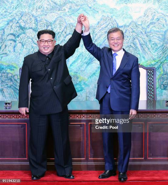 North Korean leader Kim Jong Un and South Korean President Moon Jae-in pose for photographs after signing the Panmunjom Declaration for Peace,...