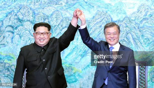 North Korean leader Kim Jong Un and South Korean President Moon Jae-in pose for photographs after signing the Panmunjom Declaration for Peace,...