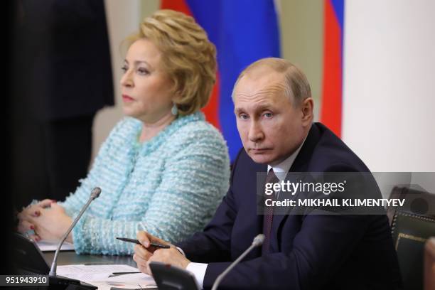 Russian President Vladimir Putin and Chairwoman of the Russian Federation Council Valentina Matviyenko attend a meeting with members of the...