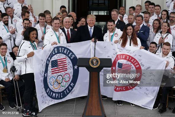 President Donald Trump is presented with two flags as he hosts Team USA at the North Portico of the White House April 27, 2018 in Washington, DC....