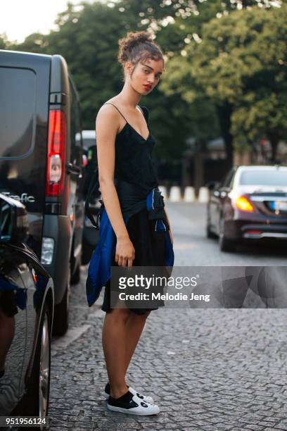Brazilian model Ellen Rosa wears a black slip dress and Panda slip-on shoes on July 02, 2017 in Paris, France.
