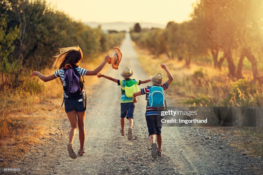 Three kids running on last day of school