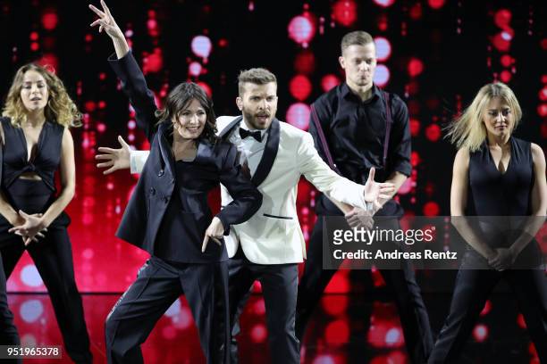 President of the German Film Academy Iris Berben and Host Edin Hasanovic perform on stage during the Lola - German Film Award show at Messe Berlin on...