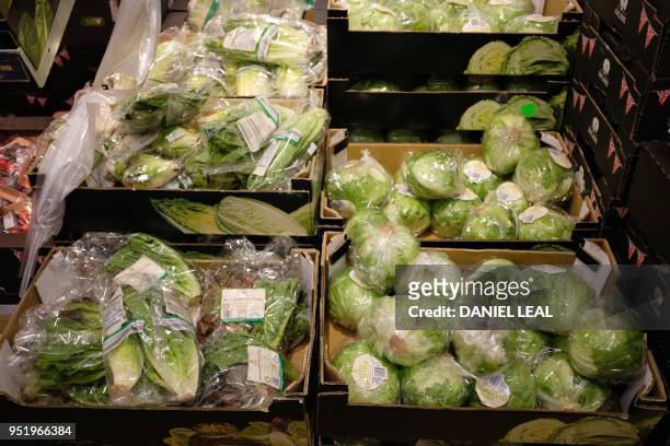Lettuces packaged in plastic are pictured in a supermarket in north London, on April 27, 2018. 42 firms, responsible for 80 percent of plastic...