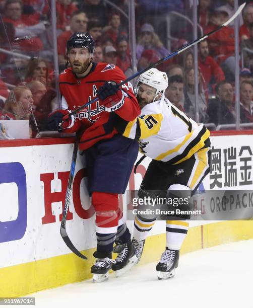Riley Sheahan of the Pittsburgh Penguins holds on to Brooks Orpik of the Washington Capitals in Game One of the Eastern Conference Second Round...