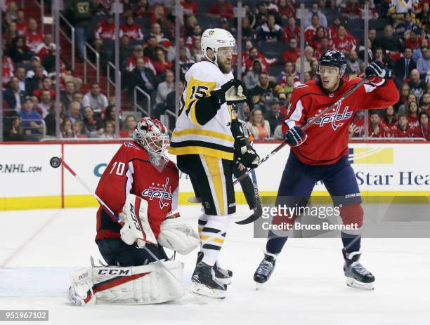 The puck gets past Braden Holtby of the Washington Capitals as he is screened by Riley Sheahan of the Pittsburgh Penguins in Game One of the Eastern...