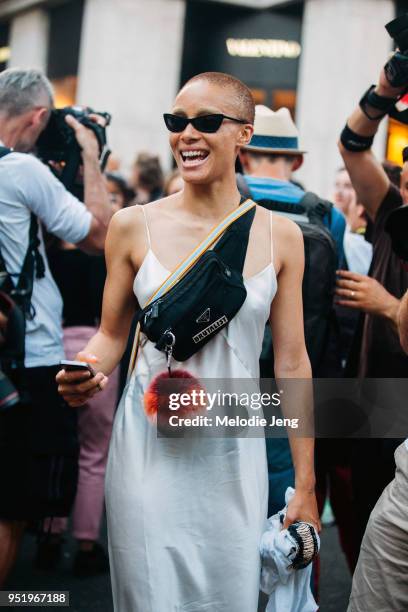 Model Adwoa Aboah wears black sunglasses, a tooth accessory, a Prada fanny pack with a "Brutalist" pin, a Fendi fur charm, and a slip dress on July...