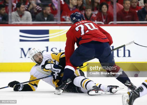 Riley Sheahan of the Pittsburgh Penguins is dumped by Lars Eller of the Washington Capitals in Game One of the Eastern Conference Second Round during...