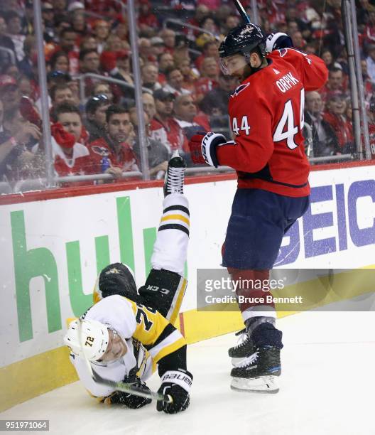 Patric Hornqvist of the Pittsburgh Penguins is tripped by by Brooks Orpik of the Washington Capitals in Game One of the Eastern Conference Second...