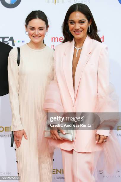 Lea van Acken and Nilam Farooq attend the Lola - German Film Award red carpet at Messe Berlin on April 27, 2018 in Berlin, Germany.