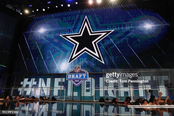 The Dallas Cowboys logo is seen on a video board during the first round of the 2018 NFL Draft at AT&T Stadium on April 26, 2018 in Arlington, Texas.