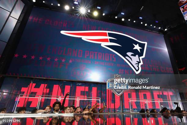 The New England Patriots logo is seen on a video board during the first round of the 2018 NFL Draft at AT&T Stadium on April 26, 2018 in Arlington,...