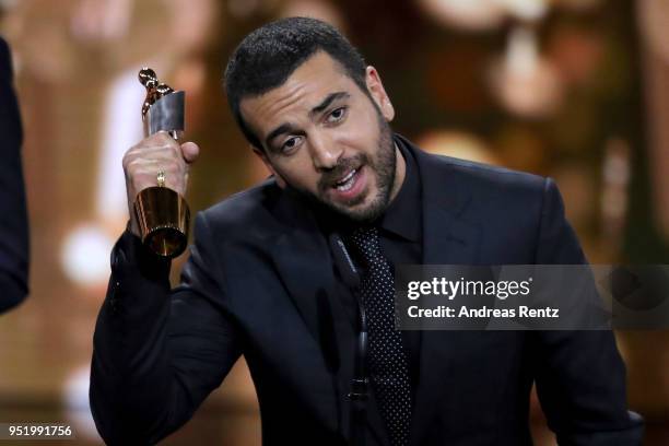 Elyas M'Barek accepts the award 'Biggest Movie Audience' for the film 'Fack ju Goehte' on stage during the Lola - German Film Award show at Messe...