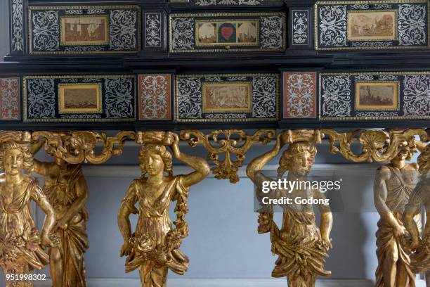 Vaux-le-vicomte castle. King's closet. Inlaid ebony and marquetry cabinet . Caryatids symbolizing the 4 seasons. France.