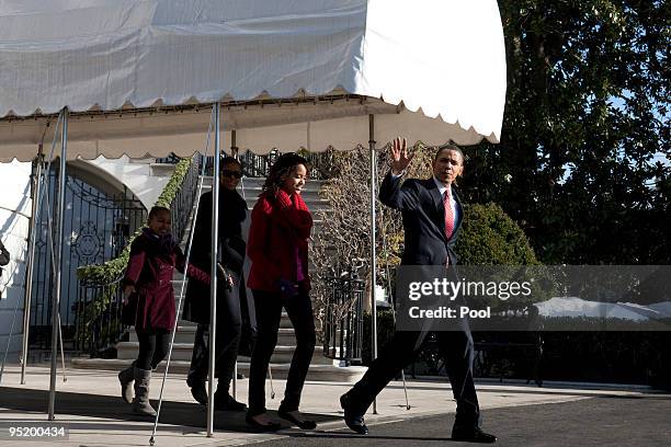 President Barack Obama, first lady Michelle Obama and their children Sasha and Malia leave the White House December 24, 2009 in Washington, DC. The...