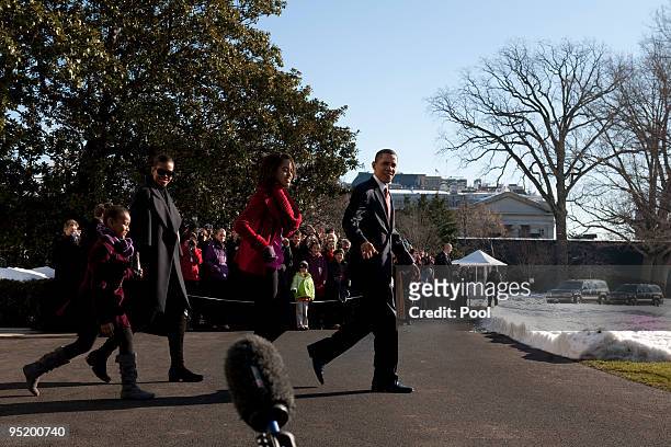 President Barack Obama, first lady Michelle Obama and their children Sasha and Malia leave the White House December 24, 2009 in Washington, DC. The...