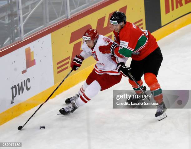 Bence Stipsicz of Hungary challenges Krystian Dziubinski of Poland during the 2018 IIHF Ice Hockey World Championship Division I Group A match...