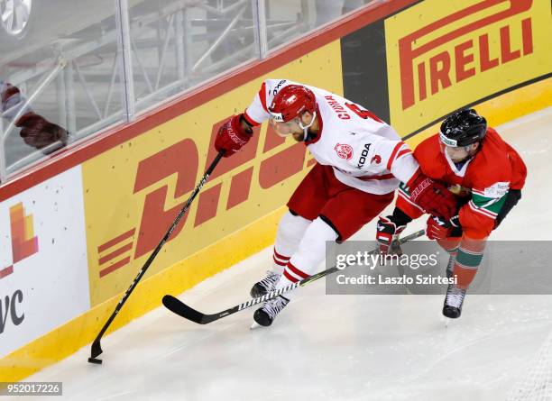 Christopher Bodo of Hungary challenges Bartosz Ciura of Poland during the 2018 IIHF Ice Hockey World Championship Division I Group A match between...