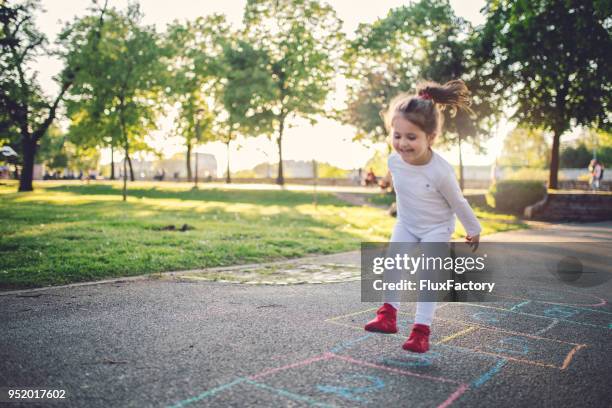 happy child on a playground - hopscotch stock pictures, royalty-free photos & images