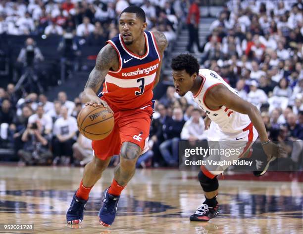 Bradley Beal of the Washington Wizards dribbles the ball as Kyle Lowry of the Toronto Raptors defends during the first half of Game Five in Round One...