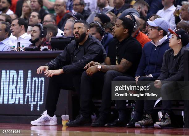 Singer Drake reacts from his courtside seat during the first half of Game Five between the Washington Wizards and the Toronto Raptors in Round One of...