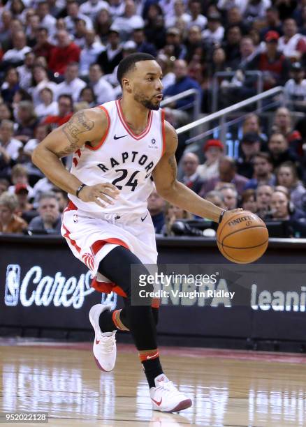 Norman Powell of the Toronto Raptors dribbles the ball during the second half of Game Five against the Washington Wizards in Round One of the 2018...