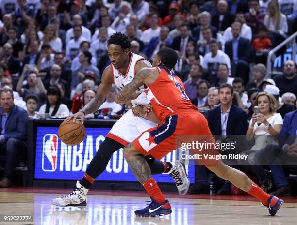 DeMar DeRozan of the Toronto Raptors dribbles the ball as Bradley Beal of the Washington Wizards defends during the second half of Game Five in Round...