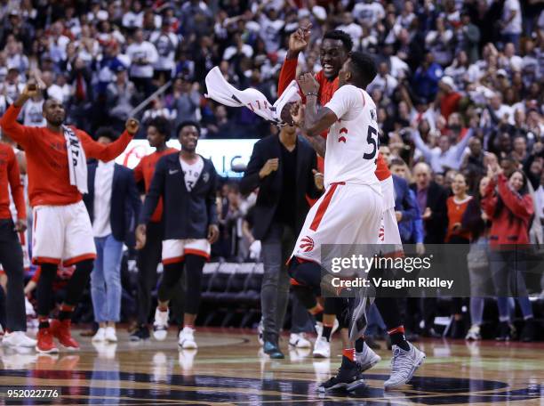 Delon Wright of the Toronto Raptors celebrates a basket with Pascal Siakam during the second half of Game Five against the Washington Wizards in...