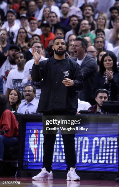 Singer Drake reacts from his courtside seat during the second half of Game Five between the Washington Wizards and the Toronto Raptors in Round One...