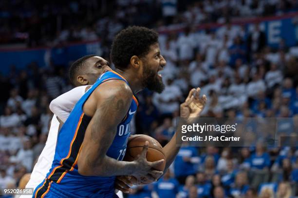 Paul George of the Oklahoma City Thunder tries to shoot over Ekpe Udoh of the Utah Jazz during game 5 of the Western Conference playoffs at the...