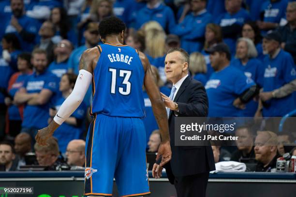 Billy Donovan coach of the Oklahoma City Thunder talks to Paul George of the Oklahoma City Thunder during game 5 of the Western Conference playoffs...