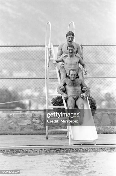 England footballers top to bottom: Terry Butcher, Kenny Sansom and Ray Wilkins slides into the swimming pool at the Cima Club in Monterrey, Mexico...