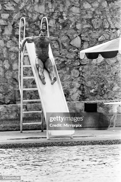 England footballer Ray Wilkins slides into the swimming pool at the Cima Club in Monterrey, Mexico where the England team are based prior to the 1986...