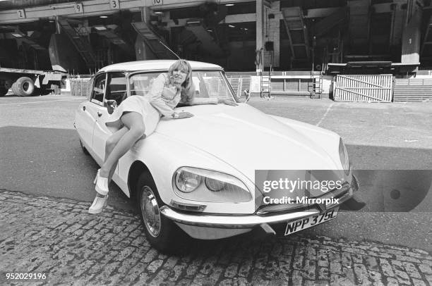 Reveille model seen here posing with a Citroen DS car which is a top prize in the Reveille win a car competition circa 1972.