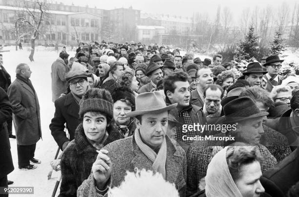 For the first time since its erection, the Berlin Wall is opened for border crossings for 18 days over the Christmas period. Many queued for passes...