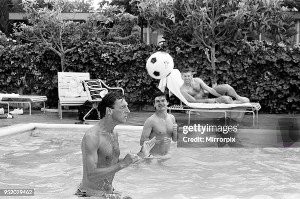 England footballers Alvin Martin and Steve Hodge playing head tennis in the swimming pool at the Cima Club in Monterrey, Mexico where the England...