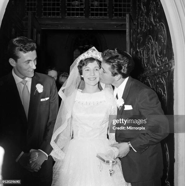 The wedding of Miss Ann Findley and Mr Bruce Welch, Cliff Richard is the best man, pictured kissing the bride. London, August 1959.