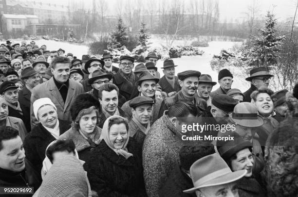 For the first time since its erection, the Berlin Wall is opened for border crossings for 18 days over the Christmas period. Many queued for passes...