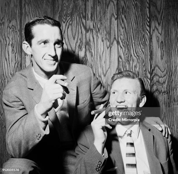 Everton football players Roy Vernon and Jimmy Gabriel smoking cigars as they celebrate their earlier 2-0 triumph over Leeds United in the FA Cup...