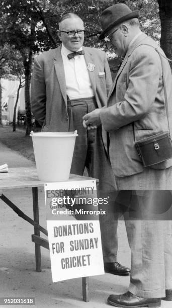 One of the 6000 spectators at Valentine Park in Ilford digs deep in his pocket to find some loose challenge for a donation before going in to watch...