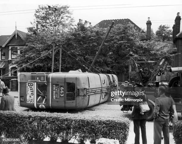 London Transport staff get ready to right a trolley bus following an accident close to Ilford Broadway, 19th June 1942.