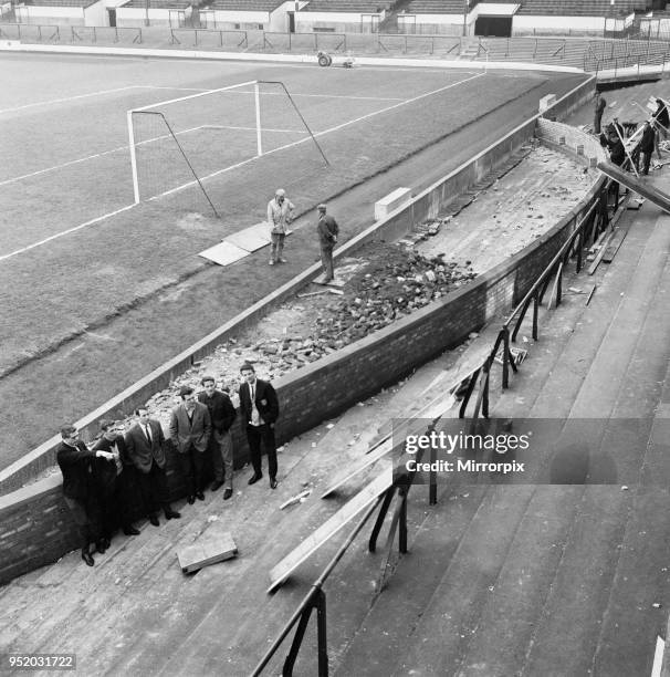 Barricades come down and a wall is erected at Goodison park, home of Everton Football club, in preparation for the 1966 World Cup. Everton players...