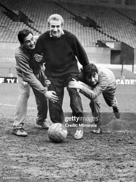 Denis Law of Manchester United training at Old Trafford with comedy double act Mike and Bernie Winters showing the only way to stop him, 17th January...