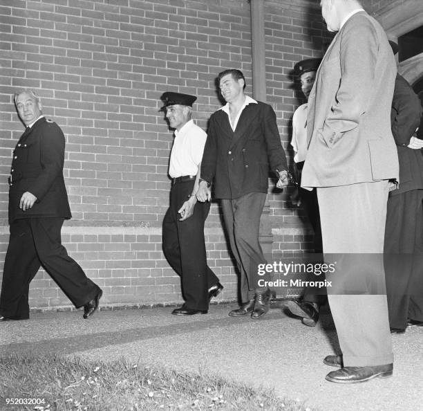 Frank Mitchell, the Mad Axeman, who escaped from Broadmoor Prison is led away from Hartley Wintney police station after being recaptured on a London...
