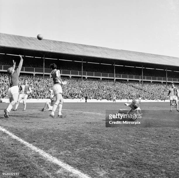 Blackburn Rovers v Manchester United, league match at Ewood Park, Saturday 3rd April 1965. On ground, Denis Law hooks the ball for goal, but it just...