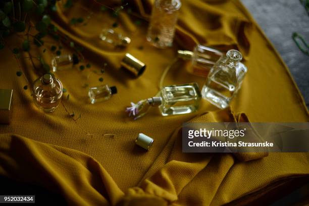 perfume bottles on a yellow background - perfume atomizer stock pictures, royalty-free photos & images