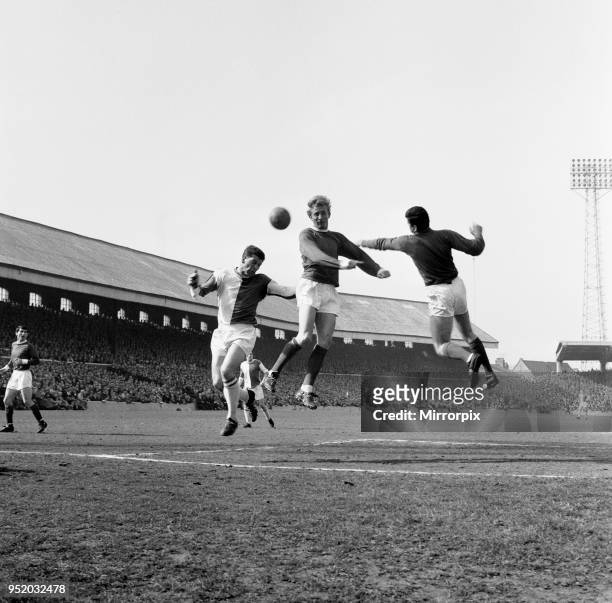 Blackburn Rovers v Manchester United, league match at Ewood Park, Saturday 3rd April 1965. Denis Law in defence, aids keeper Pat Dunne, by clearing...