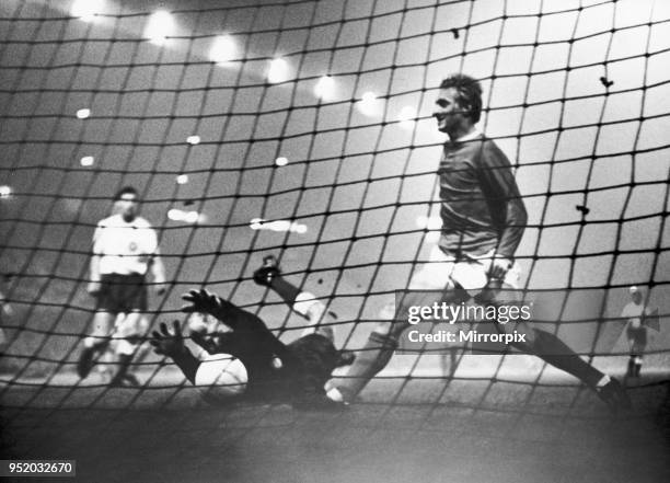 Manchester United v HJK Helsinki. HJK keeper claws for the ball but its to late as Denis Law make's sure the balls in the back of the net to give...